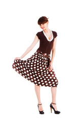 Young modest beautiful girl in spotted skirt