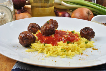 meatballs with organic curry rice on a plate