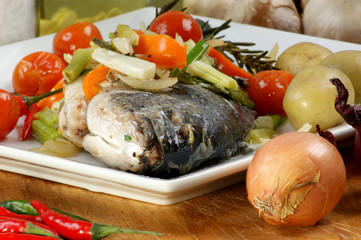 see bream with mediterranean vegetable on a plate