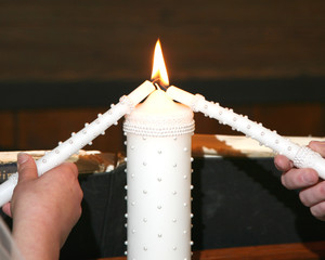 Lighting the unity candle at a wedding