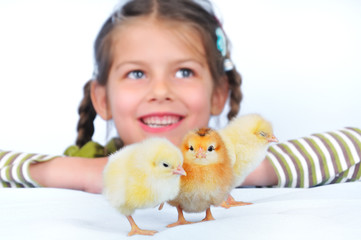 sweet little girl and chickens. focus on chickens