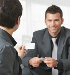 Business people changing cards