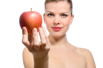 beautiful young blonde woman offering red apple, Focus on apple