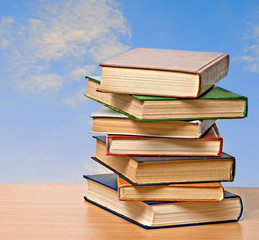 Pile of books  on desk