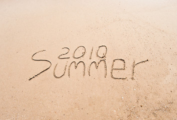 Inscription on wet sand 