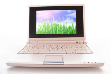 White  laptop with green landscape wallpaper on a white backgrou