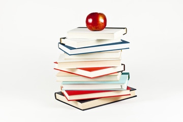 Pile of Books and Red Apple