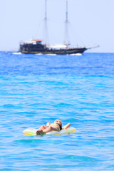 woman in bikini on a mattress in the sea