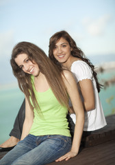 Two young women having fun at the sea