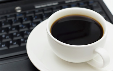 Cup of coffee and the computer