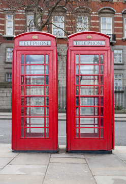 A pair of typical red phone booths in London