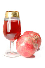 Glass of fresh juice and two pomegranates