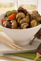 Spanish cuisine. Snails in sauce.
