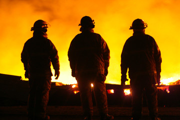 A silhouette of three fire fighters © Kevin Kratka