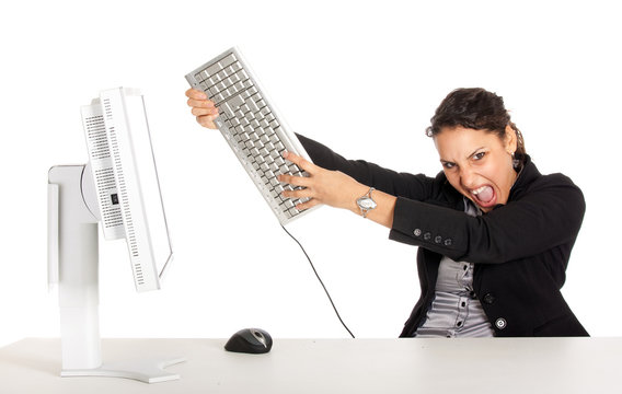 furious business woman throwing keyboard