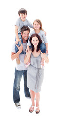 Fototapeta premium Smiling parents giving their children piggyback ride