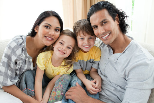 Portrait of a smiling family sitting on sofa