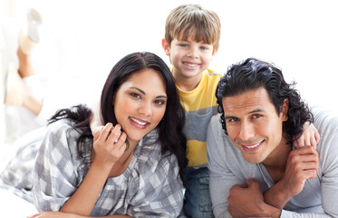 Portrait of a loving family lying on the floor