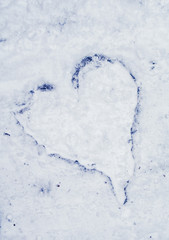 heart on asphalt in snow