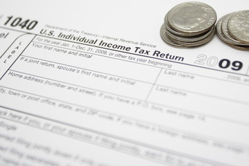 Finance concept with 1040 tax form and coins