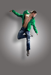 modern dancer poses in front of the old dirty wall.