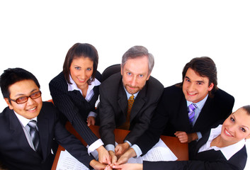 Business men and women working on blue prints.