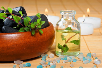 bottle of massage oil and candles for a spa treatment