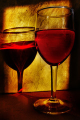 single wine glass and reflection in warm evening sunlight