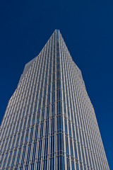 Obraz premium Blue Glass and Steel Office Tower in Deep Blue Sky