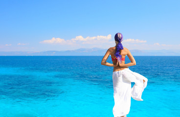 Photograph of a beautiful woman in a sarong meditating