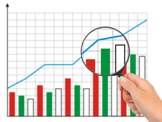 Hand with magnifying glass and diagram