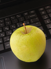 Abstract laptop with green apple
