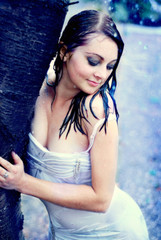 The wet girl on back background trees