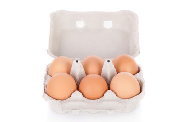Half dozen  brown chicken eggs in box  isolated