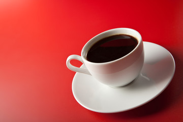 cup of coffee over red background