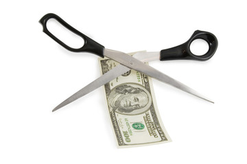 scissors cutting a 100 dollars banknote