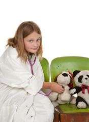 girl playing doctor with her toys