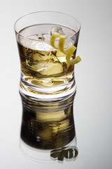 Rusty nail cocktail with lemon peel