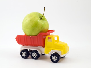 Green apple on a children's pickup truck