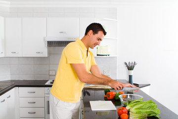 handsome young man making salad