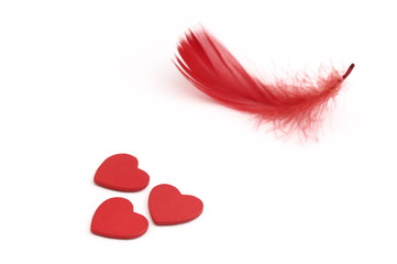 red hearts and feather isolated on white background