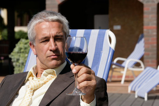 Businessman with glass of red wine