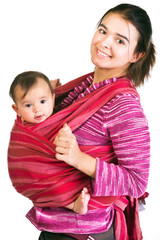 Modern young mother carrying baby in a sling