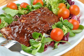 some marinated organic rib on healthy salad