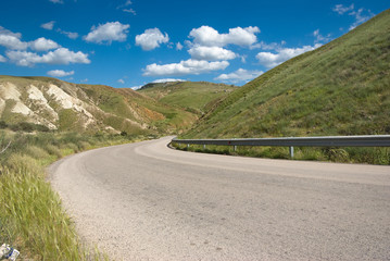 Country Road Crosses Hilly Area