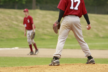 Pitcher and third baseman during a baseball game.
