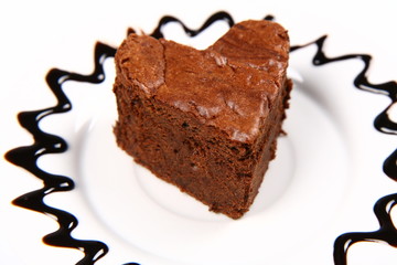 Heart shaped slice of a brownie on a plate decorated