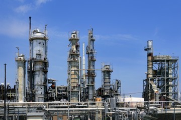 Oil industry installation, metal skyline blue sky
