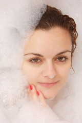 Young woman enjoys bath-foam