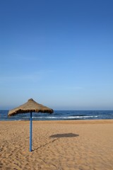 Summer vegetal beach heater wattle umbrella blue sea sky